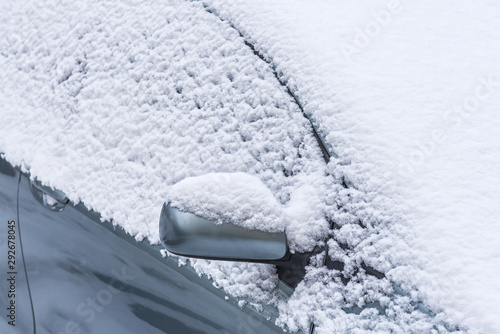 Frozen car window. Blizzart and snowstorm. Machine element covered with hoarfrost photo