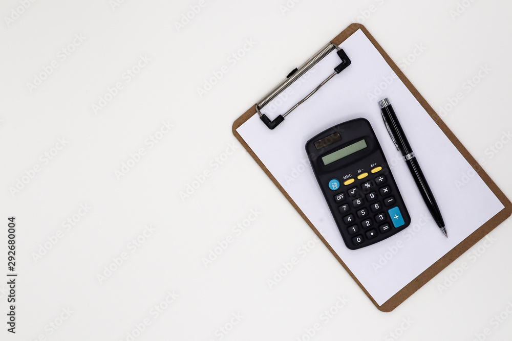 blank notepad, calculator and a pen on white office desk. - blank space for advertising text. blank notepad, calculator and a pen on white office desk. - blank space for advertising text.