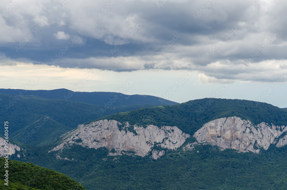 Fototapeta premium Mountains covered with forest before the rain.