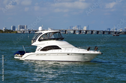 High-end cabin cruiser idling on the Florida Intra-Coastal Waterway off Miami Beach with the Julia Tuttle Causeway bridge in the background. © Wimbledon