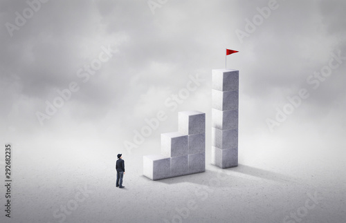 фотографія Man rising stairs to reach the top of the tower
