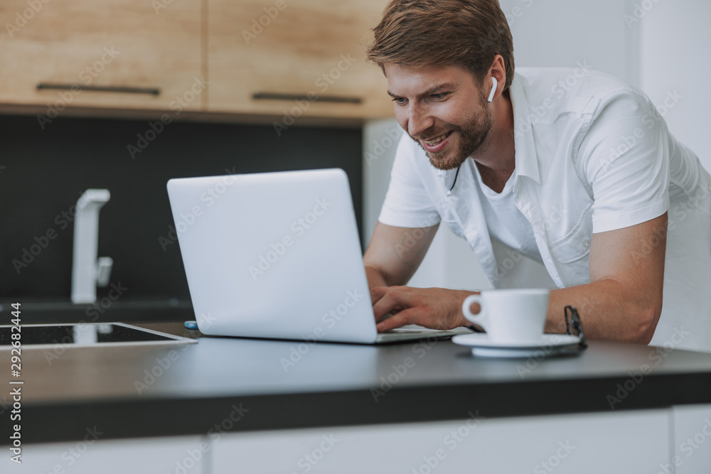 Happy man sending messages to his girlfriend Happy man sending messages to his girlfriend