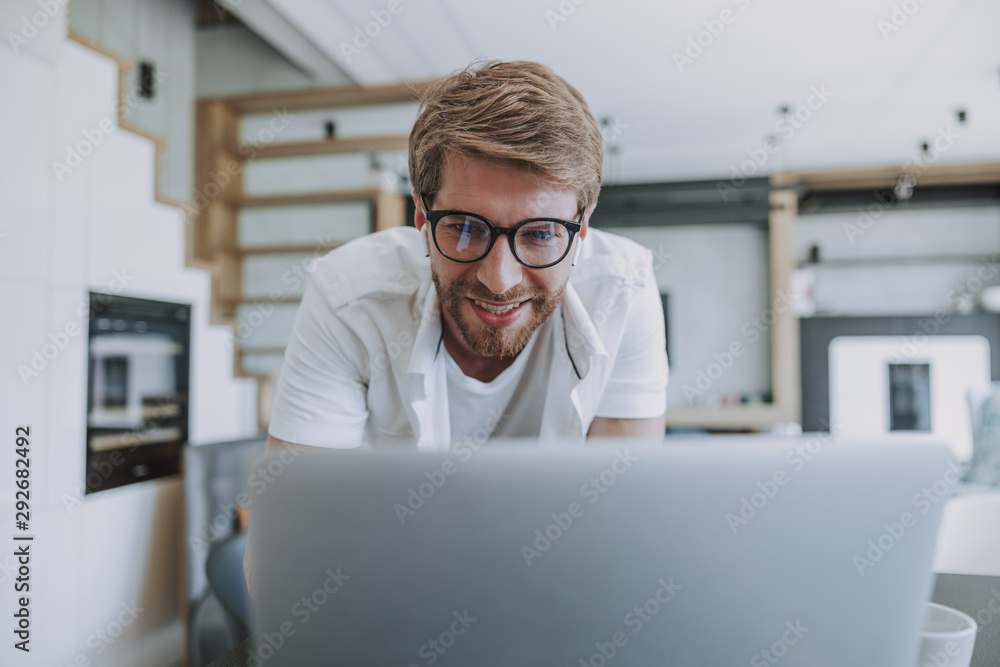 Cheerful man making a video call to his friend Cheerful man making a video call to his friend