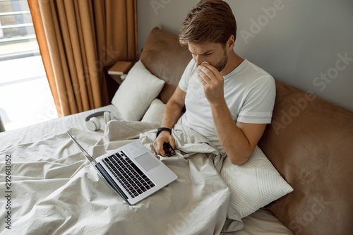 Man working remotely inspite of having cold photo