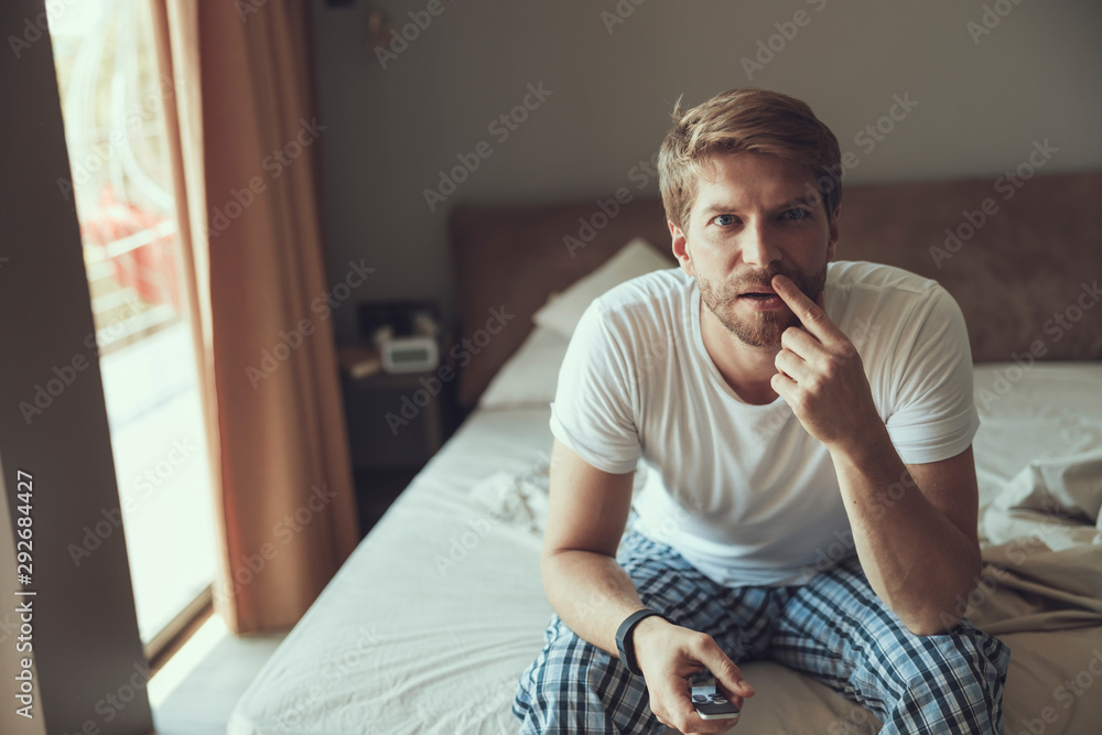 Fototapeta premium Attentive young man watching a football match