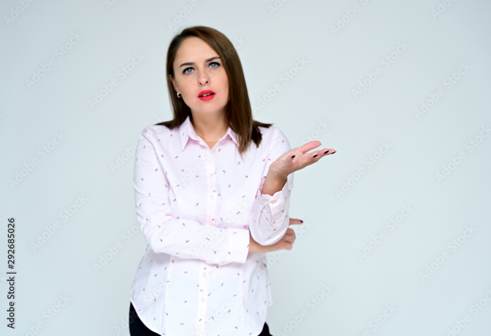 © Вячеслав Чичаев - Portrait on a white background of a pretty adult brunette executive woman in a light business shirt. Serious business look and communication.