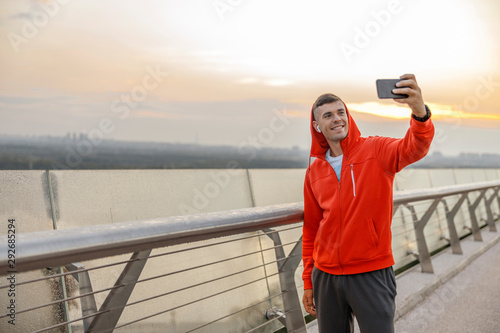 Man taking a selfie on a bridge