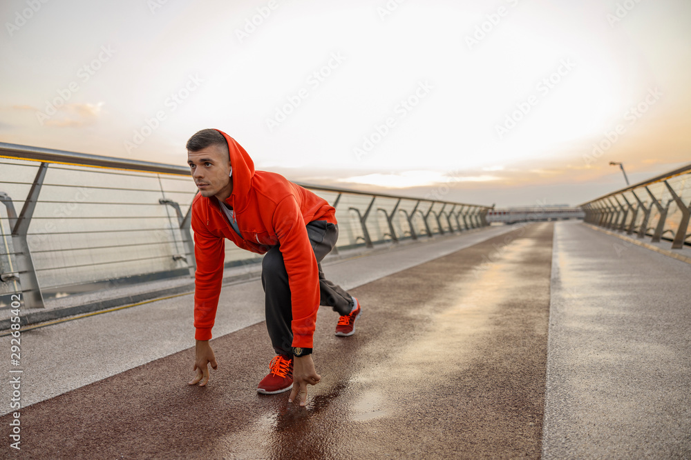 Attractive motivated man preparing for a run