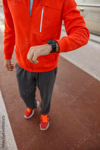 Male athlete checking the sports watch outdoors