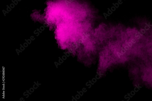 Pink powder explosion on black background.Pink dust splash cloud on dark background.