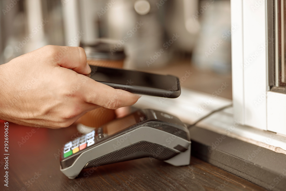 Caucasian man paying the bill in a cafe Caucasian man paying the bill in a cafe