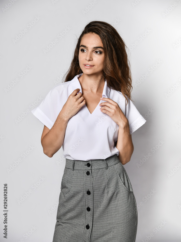 beautiful woman office manager posing in a new casual white blouse and classic straight dark skirt beautiful woman office manager posing in a new casual white blouse and classic straight dark skirt