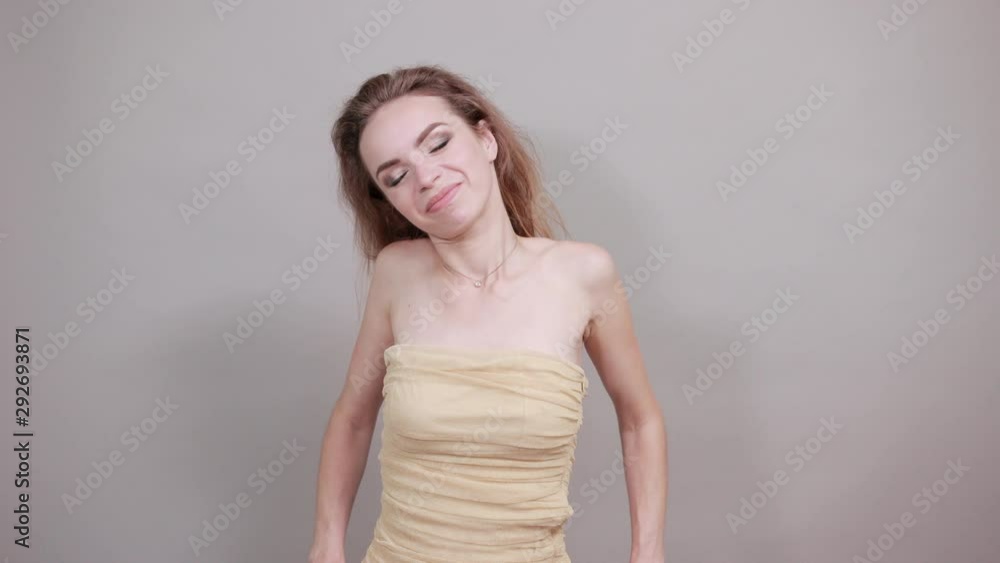 Beautiful girl in beige t-shirt over isolated white background shows emotions Beautiful girl in beige t-shirt over isolated white background shows emotions