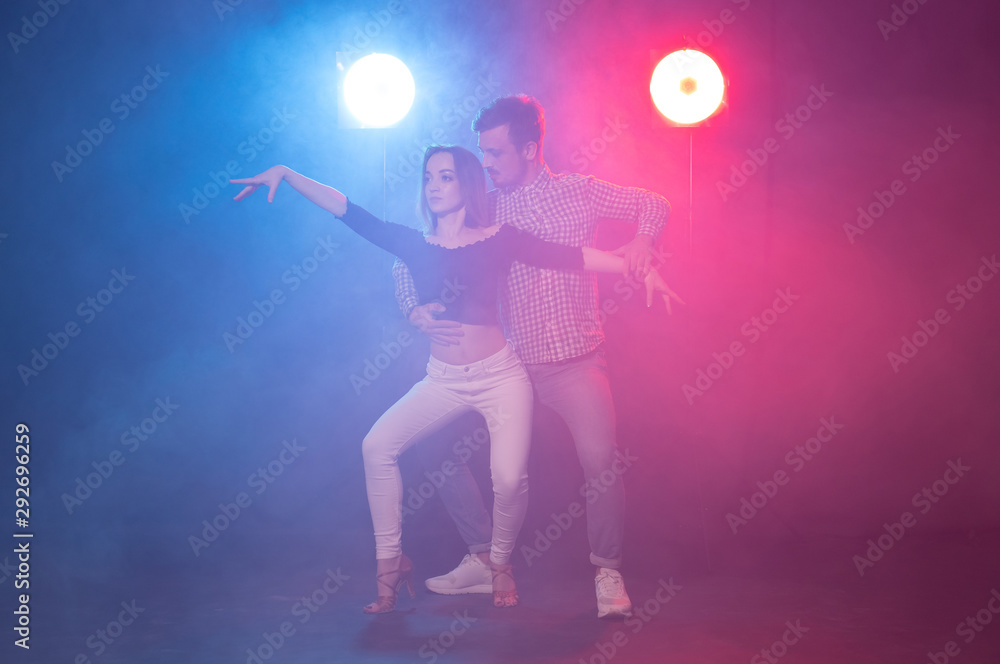 Social dance, kizomba, salsa, semba or zouk concept - a young couple dancing bachata and salsa at the disco