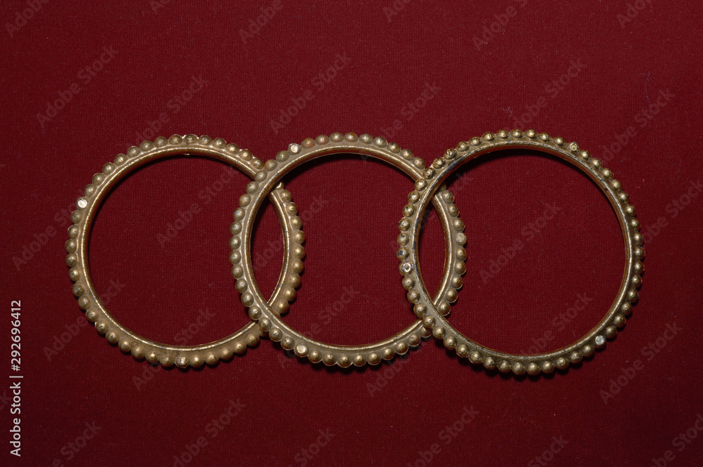 A antique handmade indian bangles isolated on red background for beautiful hands A antique handmade indian bangles isolated on red background for beautiful hands