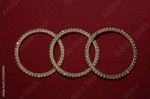 A antique handmade indian bangles isolated on red background for beautiful hands
