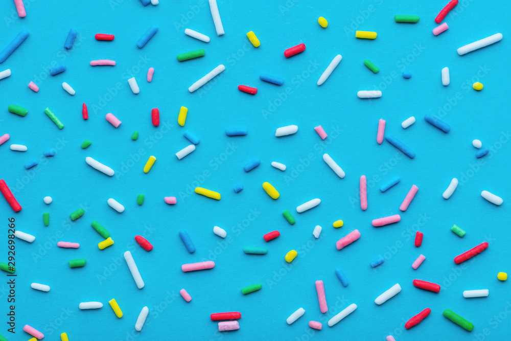 colorful sprinkles over blue background, festive decoration for Valentines day, birthday, holiday and party time