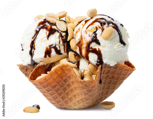 scoops vanilla ice cream decorated chocolate topping and nuts in waffle cone bowl isolated on white background, summer creative concept