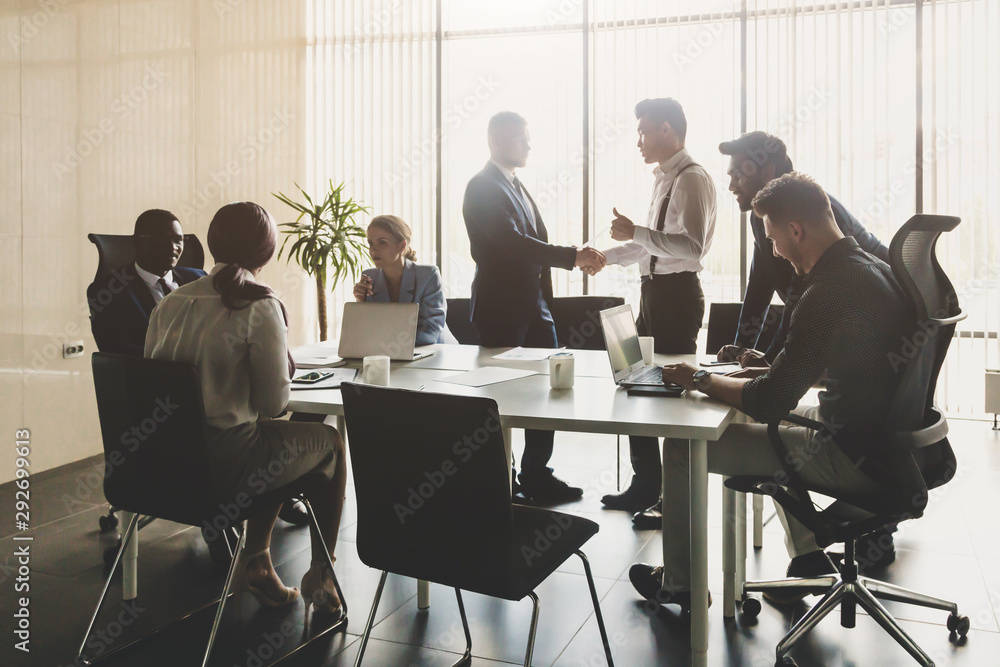 A team of young businessmen working and communicating together in an office. Corporate businessteam and manager in a meeting A team of young businessmen working and communicating together in an office. Corporate businessteam and manager in a meeting