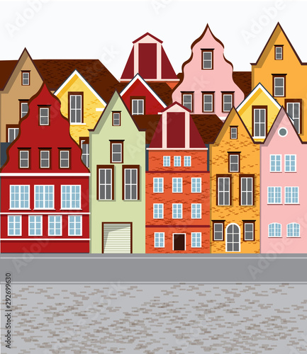 Old retro town with colorful buildings and cobblestone paved road in front. F...