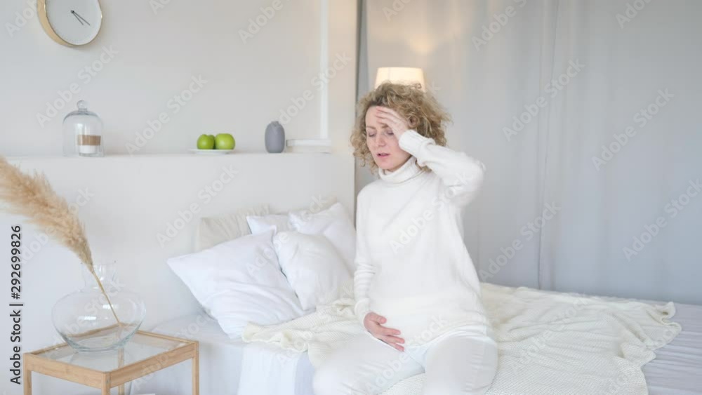 Young Pregnant Woman Suffering From Headache At Home Young Pregnant Woman Suffering From Headache At Home