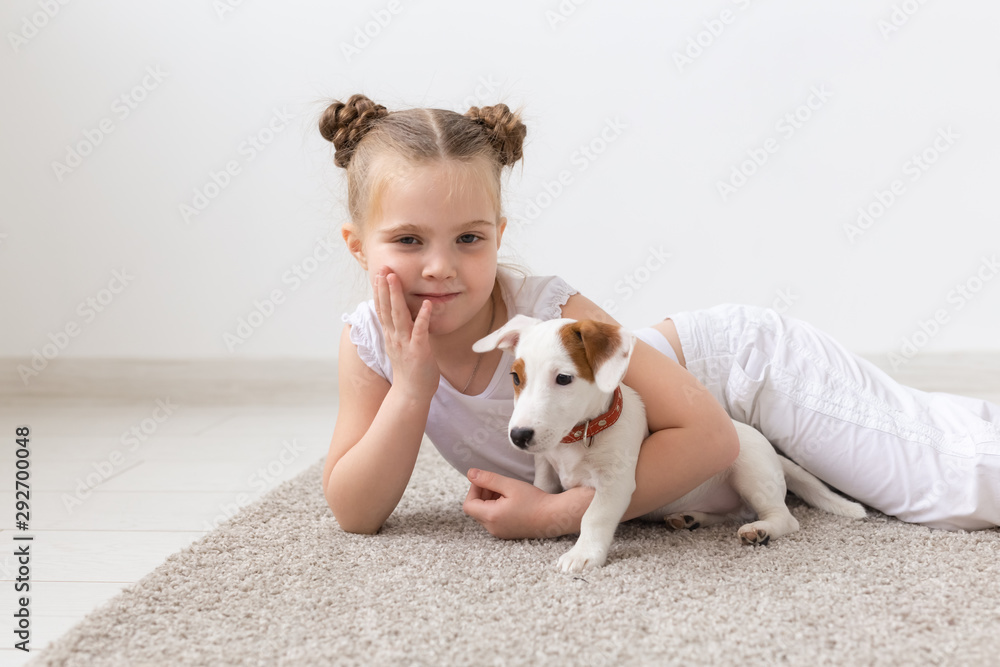 Happy cute female baby and dog is sitting in garden. Child is playing with  English Bull Terrier white dog outside in park. A little girl and his dog  Stock Photo - Alamy