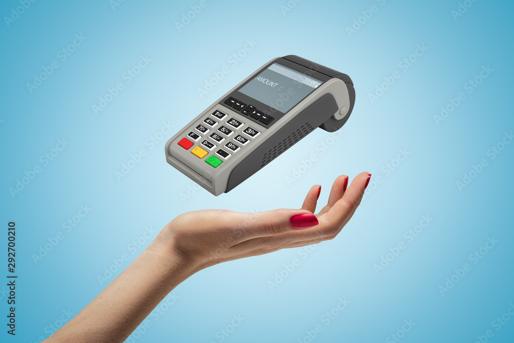 Female hand with PIN pad on blue background Female hand with PIN pad on blue background