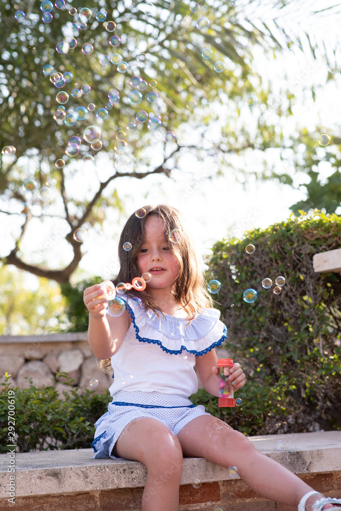 beautiful girl  Shooting Bubbles from Bubble Gun in the park