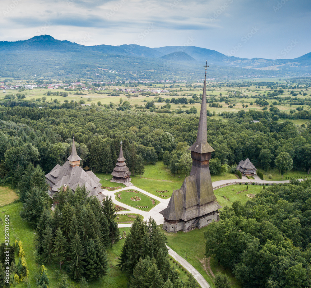 Aerial panoramic view of traditional ancient Maramures wooden orthodox church in Transylvania with highest wooden belltower in Europe, Romania. UNESCO world heritage site. Aerial panoramic view of traditional ancient Maramures wooden orthodox church in Transylvania with highest wooden belltower in Europe, Romania. UNESCO world heritage site.