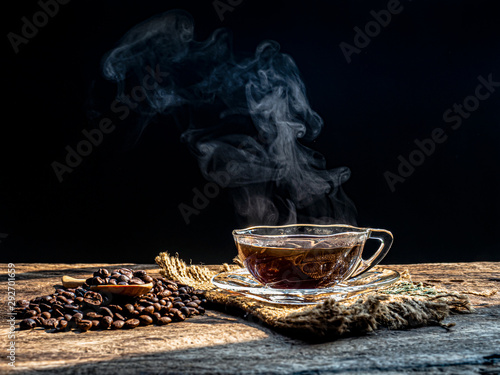 cup of  hot coffee with coffee beans on the wooden table