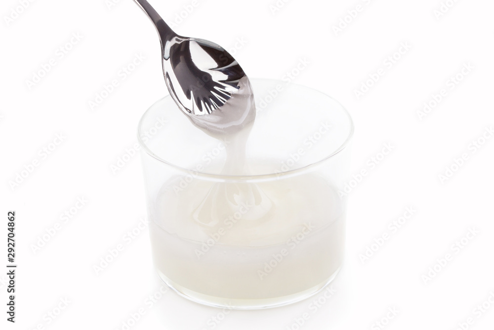 Inverted sugar syrup pouring from a spoon Inverted sugar syrup pouring from a spoon