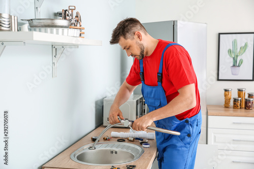 Plumber installing sink in ...