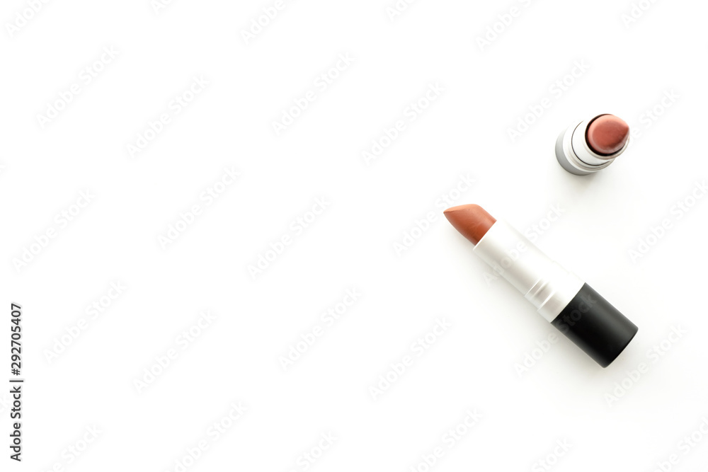 Two red tone lipsticks are on top of white table. Top view with copy space, flat lay. Two red tone lipsticks are on top of white table. Top view with copy space, flat lay.