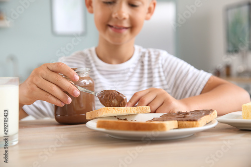 Funny little boy eating tas...