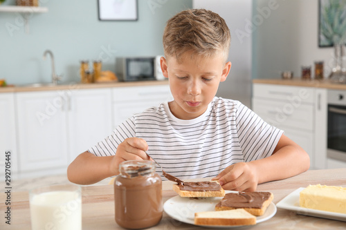 Funny little boy eating tas...