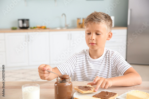 Funny little boy eating tas...