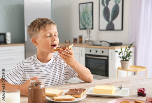 Funny little boy eating tas...