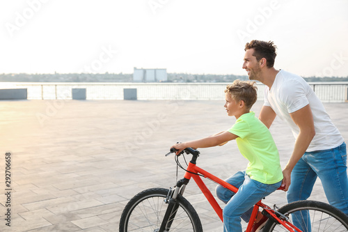 Father teaching his son to ...