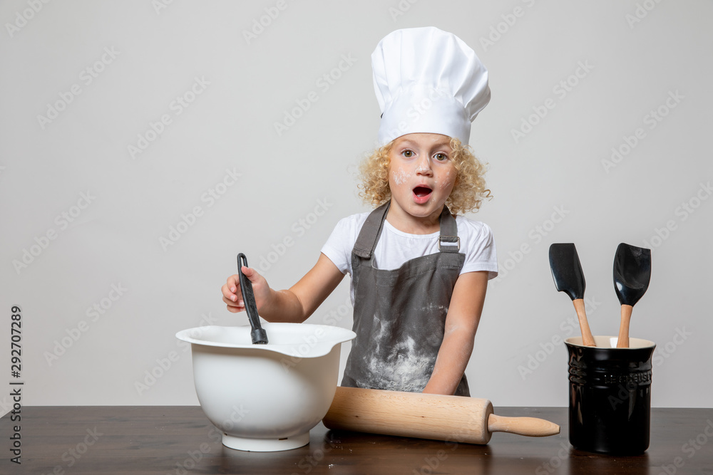 little girl in chefs hat baking covered in flour little girl in chefs hat baking covered in flour