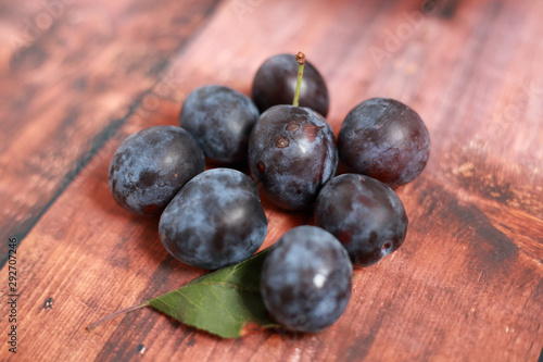 blue plums from his garden on a wooden table