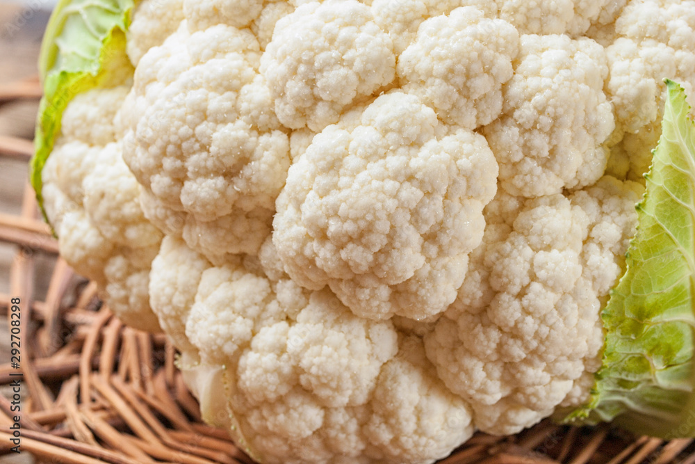A head of cauliflower lies on a table A head of cauliflower lies on a table