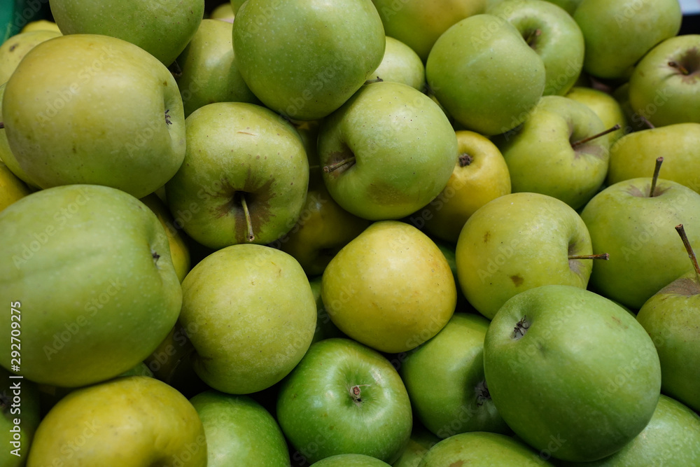 A lot of fresh green apples. Green ripe apples background. A lot of fresh green apples. Green ripe apples background.