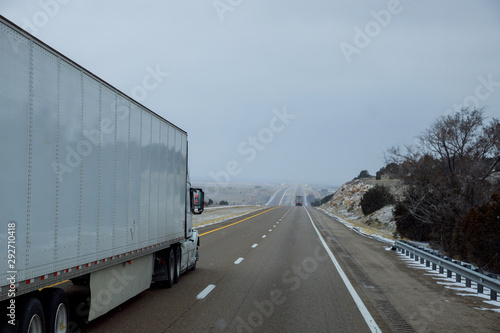 Large heavy freight truck speeding through Arizona desert