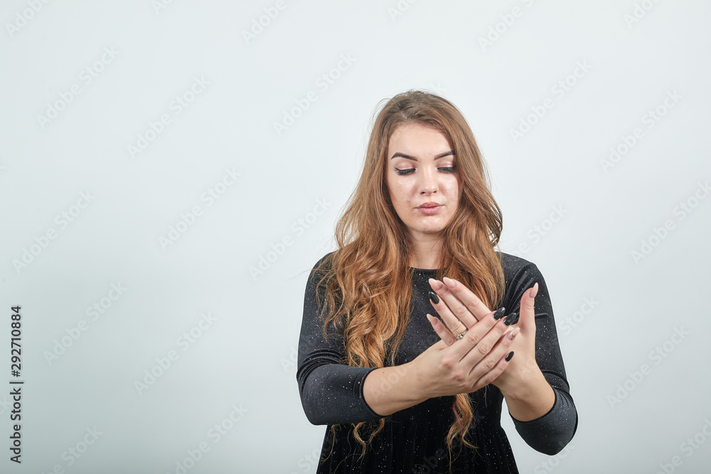 girl brown haired in black dress over isolated white background shows emotions girl brown haired in black dress over isolated white background shows emotions