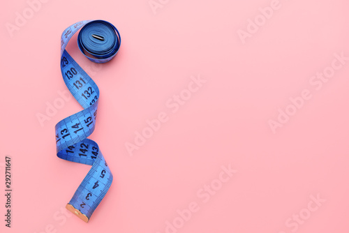 Measuring tape on color background photo