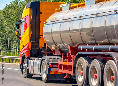 Tanker with chrome tanker on the highway. Working visit