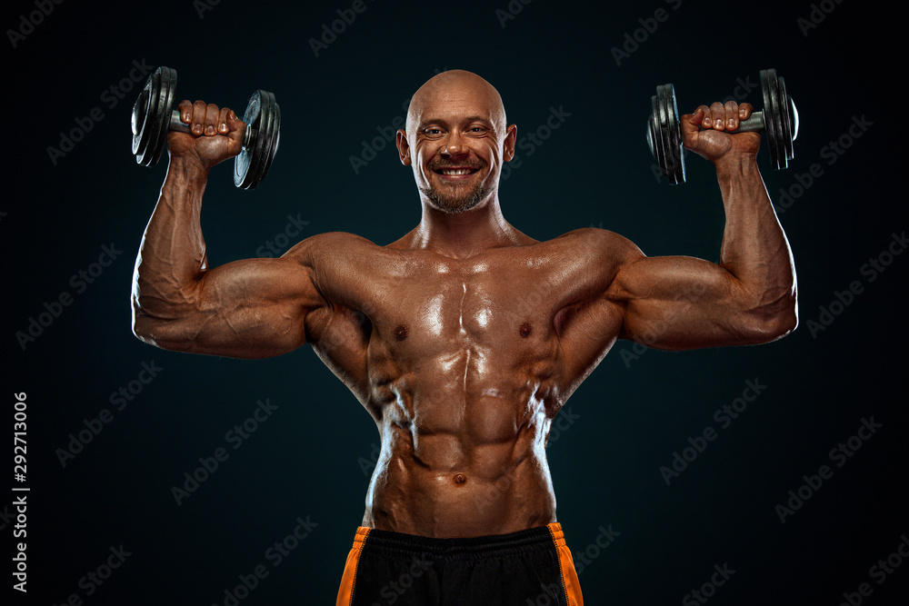 Strong and fit man bodybuilder. Sporty muscular guy with dumbbells. Sport and fitness motivation. Individual sports recreation.