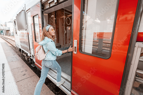 Fotografie Asian woman entering wagon of a train. Railway transport concept
