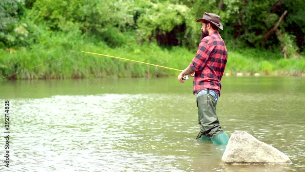 Man fishing and relaxing while enjoying hobby. Difference between fly fishing and regular fishing. Man fisherman catches a fish. Fishing became a popular recreational activity. Man fishing and relaxing while enjoying hobby. Difference between fly fishing and regular fishing. Man fisherman catches a fish. Fishing became a popular recreational activity.