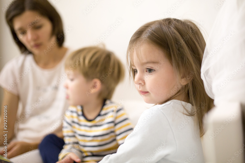 Mom with children reads a book before going to bed Mom with children reads a book before going to bed